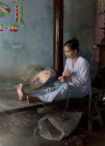A woman repairing fishing nets, Long Hai Beach A woman repairing fishing nets, Long Hai Beach
